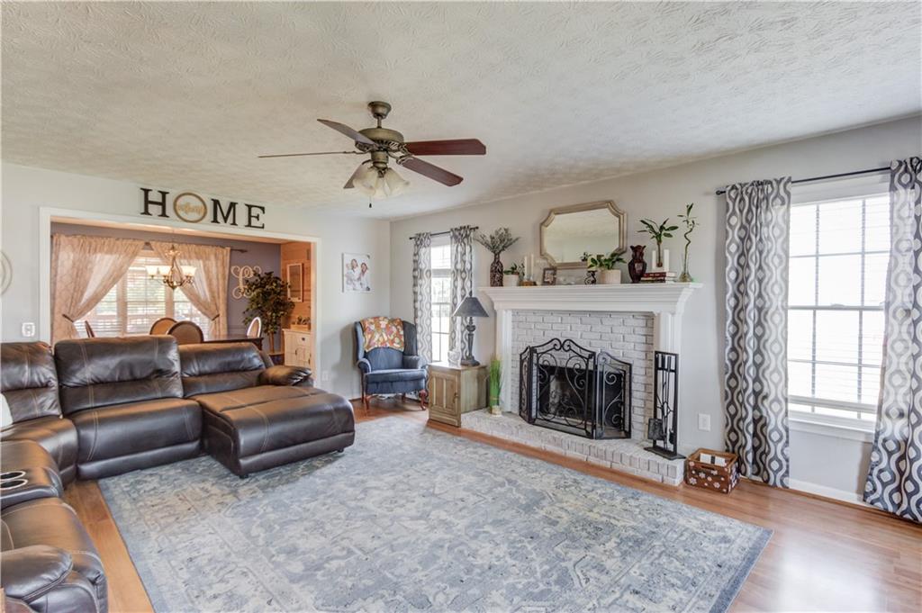 204 Angie Way Bethlehem, GA 30620 - Photo 8 of 42 a living room with furniture and a fireplace