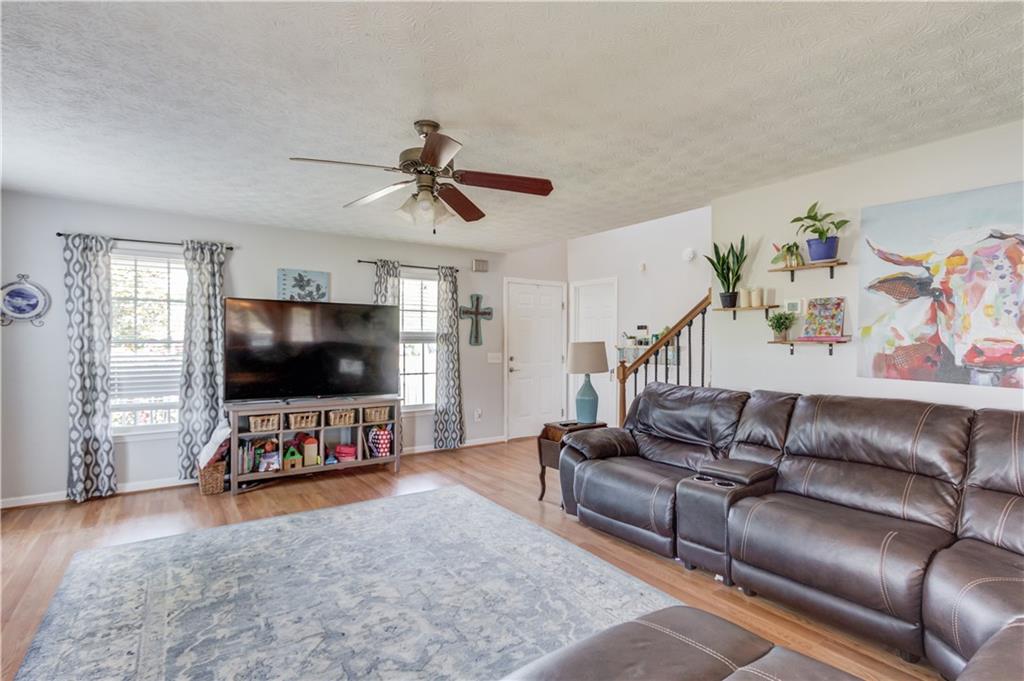 204 Angie Way Bethlehem, GA 30620 - Photo 10 of 42 a living room with furniture and a flat screen tv