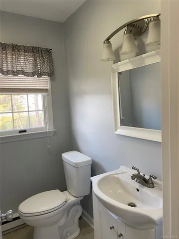 a white toilet sitting next to a bathroom sink