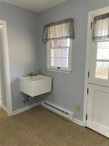 a bathroom with a sink a window and a mirror