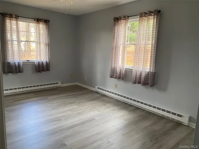 a view of a room with wooden floor and fan