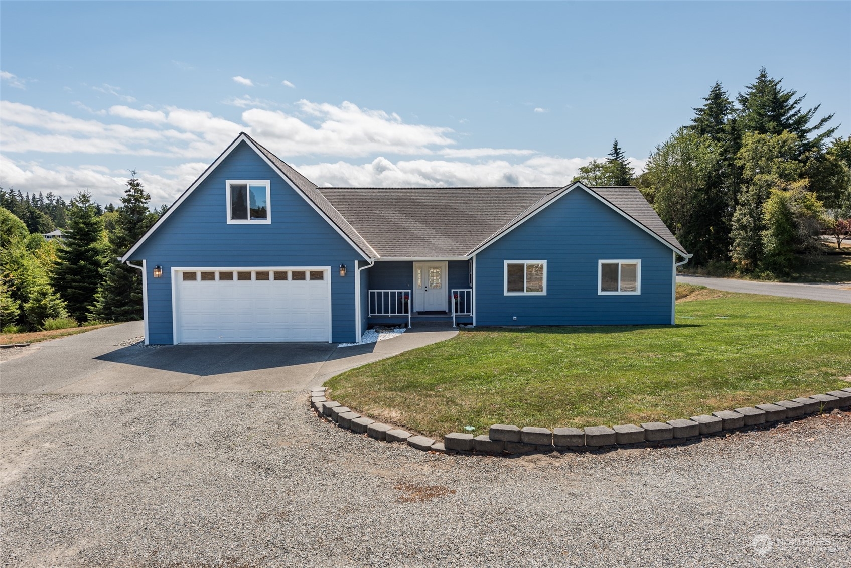 a view of a house with a yard and garage