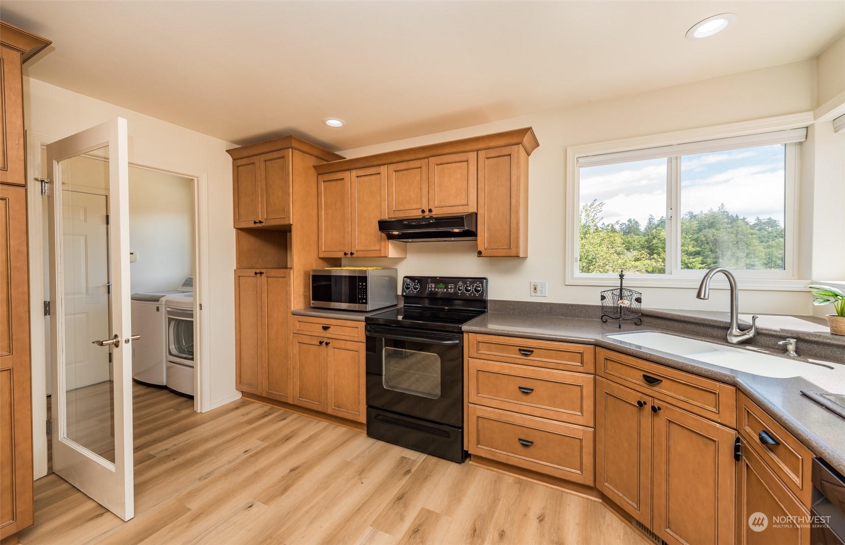 322 Ridge View Drive Sequim, WA 98382 - Photo 10 of 40 a kitchen with stainless steel appliances granite countertop a stove a sink and a refrigerator