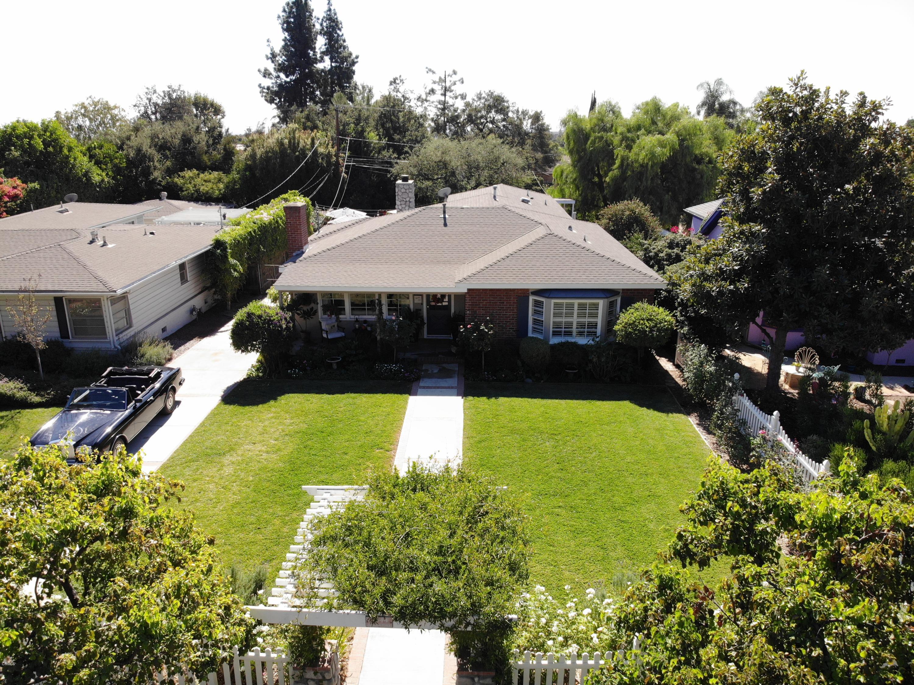 1644 Morada Place Altadena, CA 91001 - Photo 3 of 74 a view of a swimming pool with lawn chairs under an umbrella