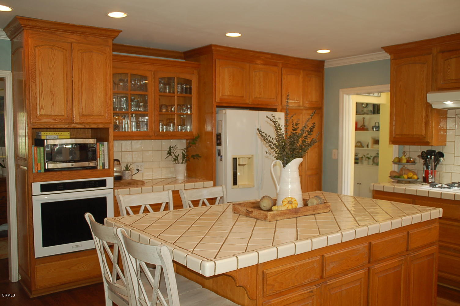 1644 Morada Place Altadena, CA 91001 - Photo 28 of 74 a kitchen with stainless steel appliances kitchen island granite countertop a table chairs in it and wooden floors