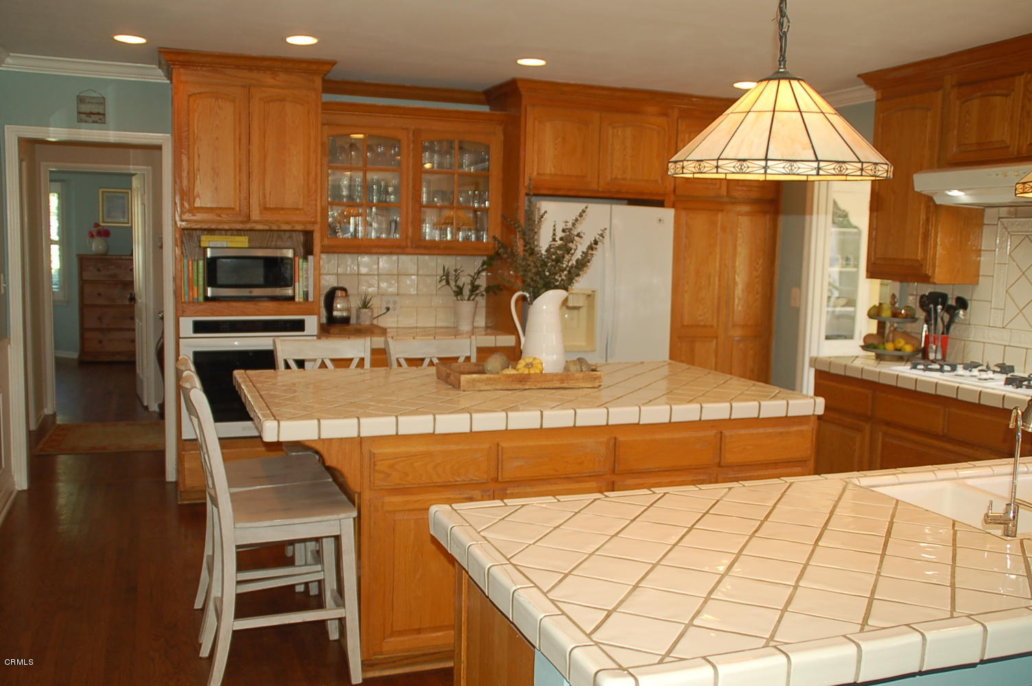1644 Morada Place Altadena, CA 91001 - Photo 31 of 74 a kitchen with kitchen island granite countertop a stove a sink and a refrigerator
