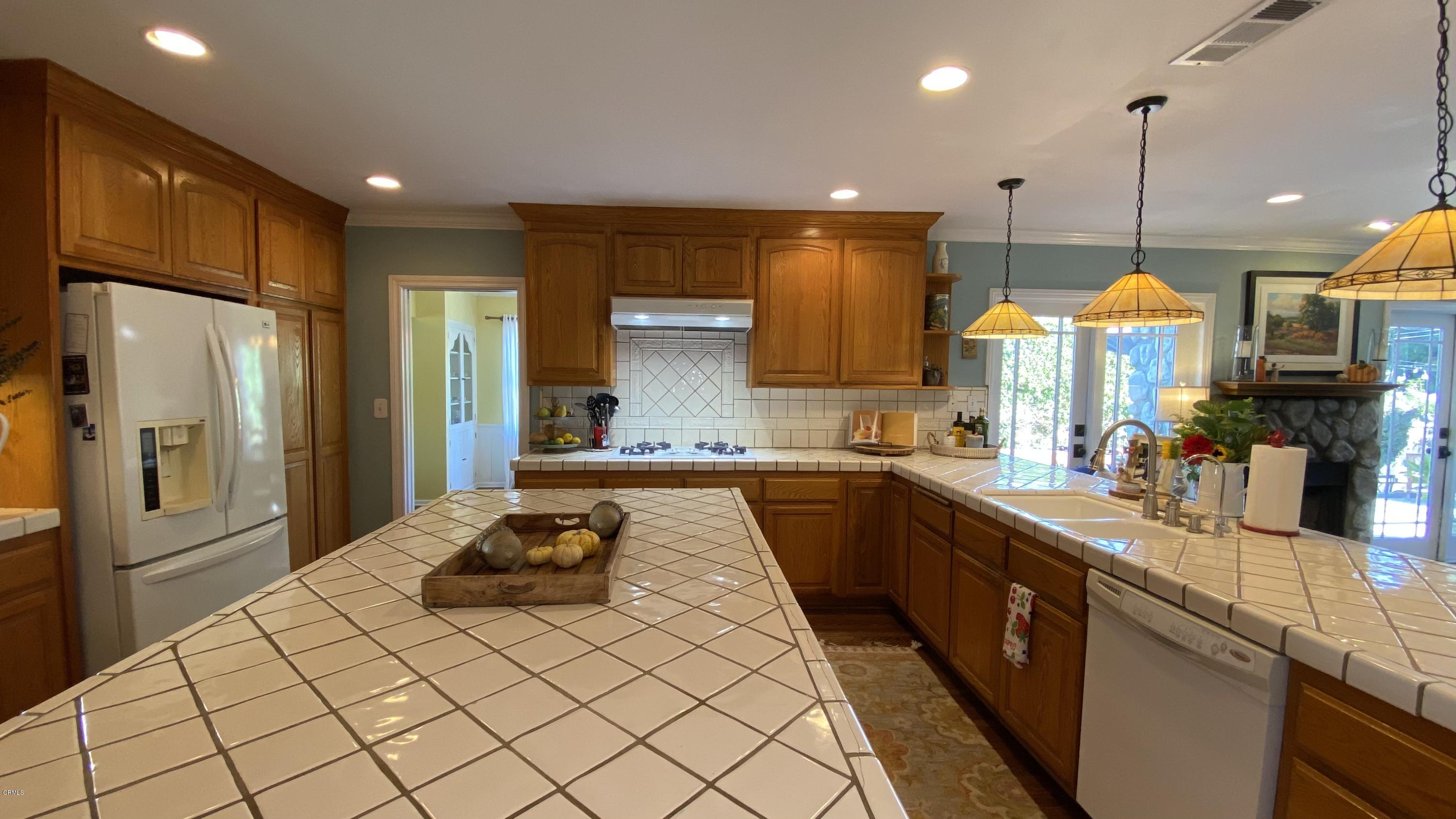 1644 Morada Place Altadena, CA 91001 - Photo 37 of 74 a kitchen with stainless steel appliances granite countertop a sink a stove and a refrigerator