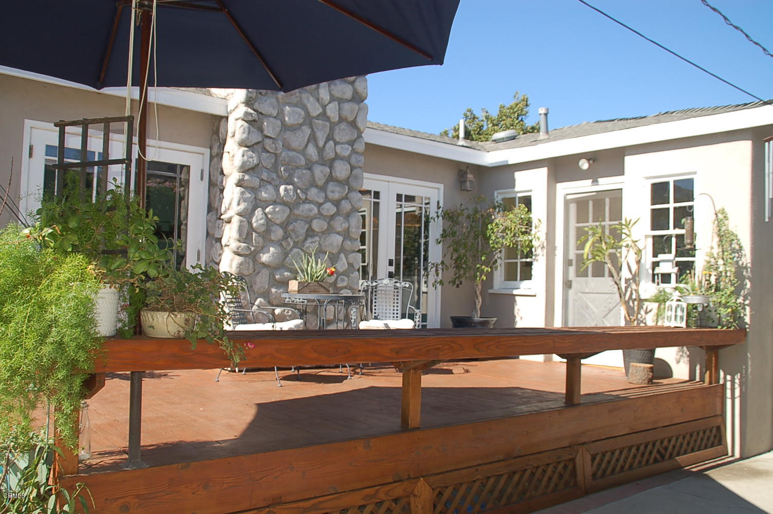 1644 Morada Place Altadena, CA 91001 - Photo 64 of 74 a view of a patio with couches table and chairs under an umbrella