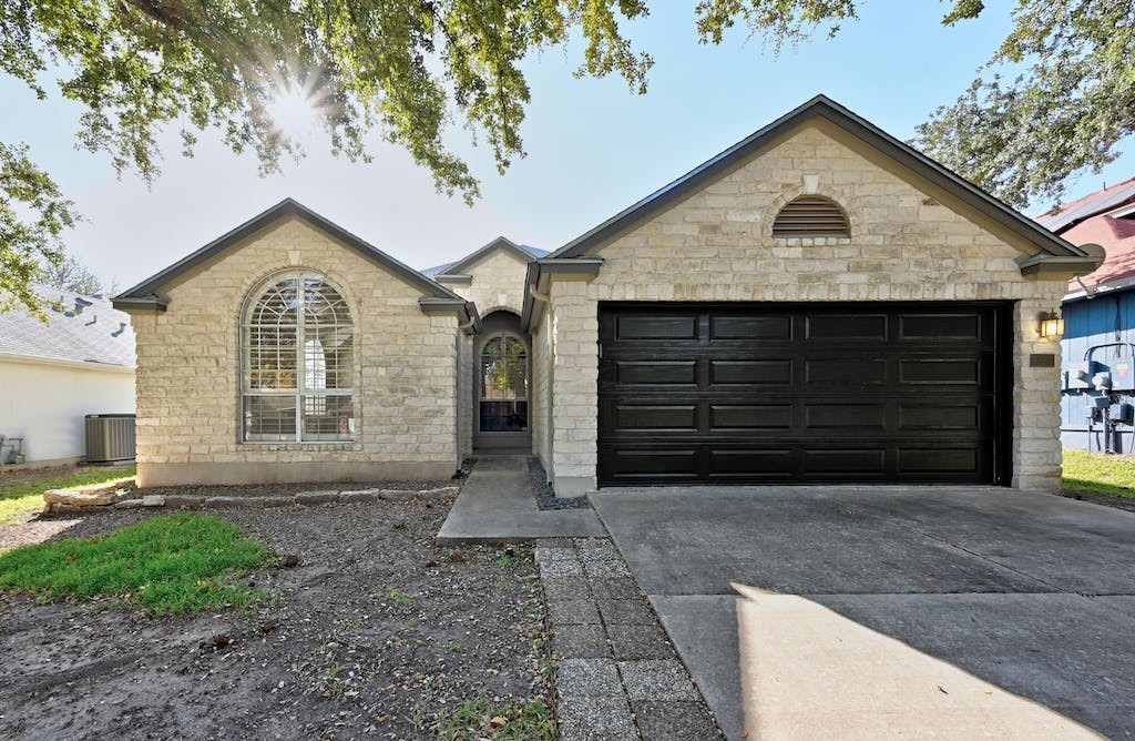 a front view of a house with garden
