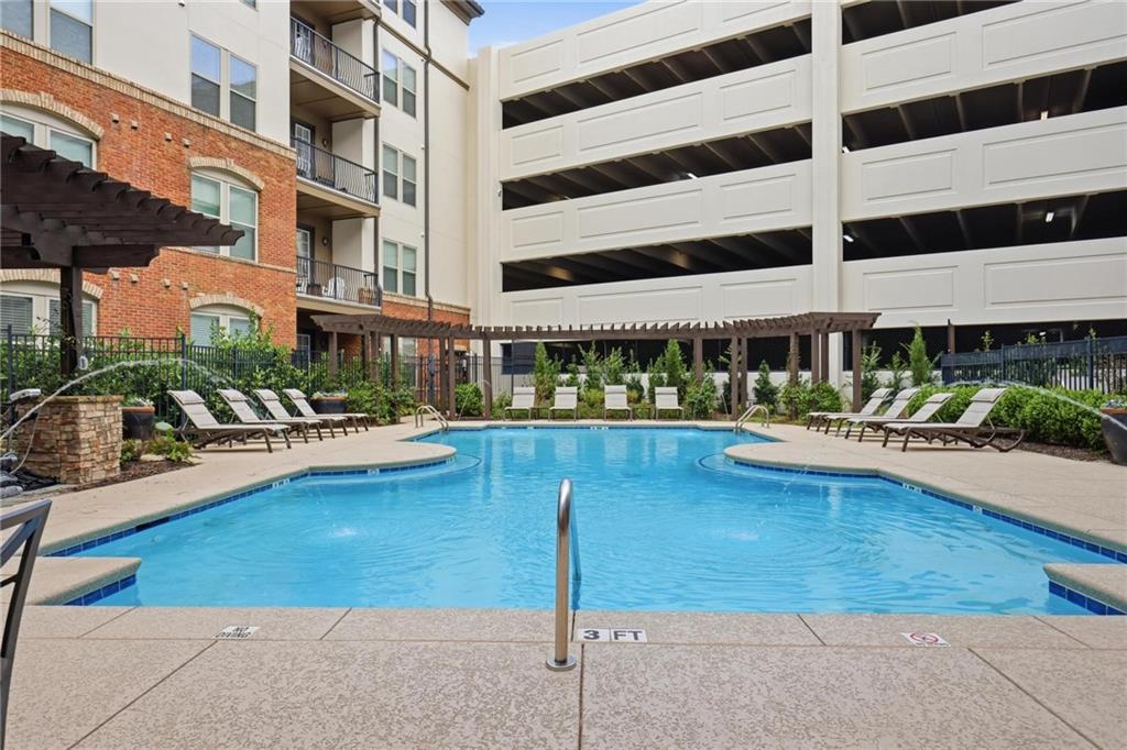 901 Abernathy Road Northeast, Unit 3080 Atlanta, GA 30328 - Photo 16 of 21 a swimming pool with outdoor seating and yard view