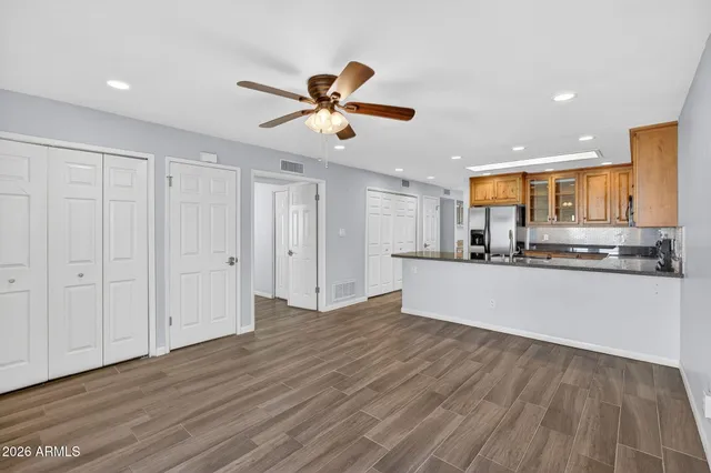 a kitchen with granite countertop a sink stove and microwave