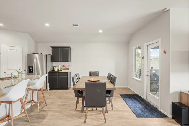 a large kitchen with a table and chairs