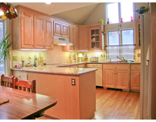 30 Abbott Road Wellesley, MA 02481 - Photo 6 of 17 a kitchen with stainless steel appliances granite countertop a sink dishwasher and cabinets with wooden floor