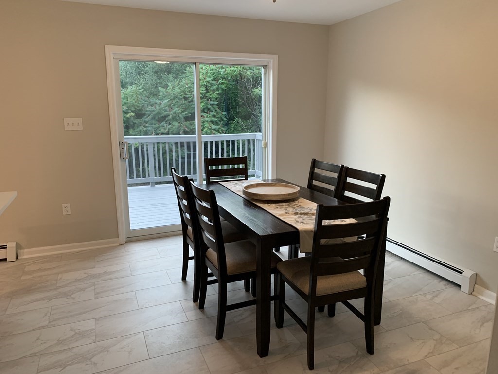 581 Warren Wright Road Belchertown, MA 01007 - Photo 12 of 25 a view of a dining room with furniture and a window