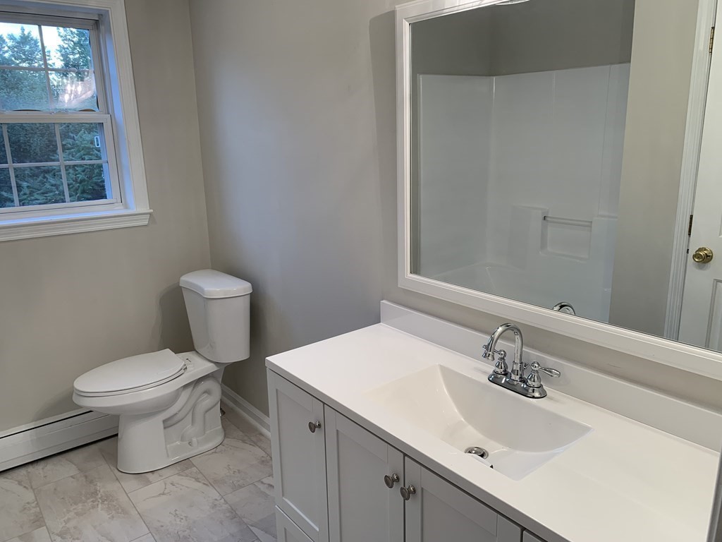 581 Warren Wright Road Belchertown, MA 01007 - Photo 20 of 25 a bathroom with a sink toilet and a mirror