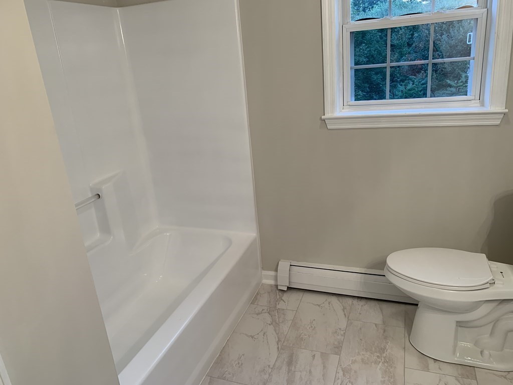 581 Warren Wright Road Belchertown, MA 01007 - Photo 21 of 25 a bathroom with a toilet and a bathtub