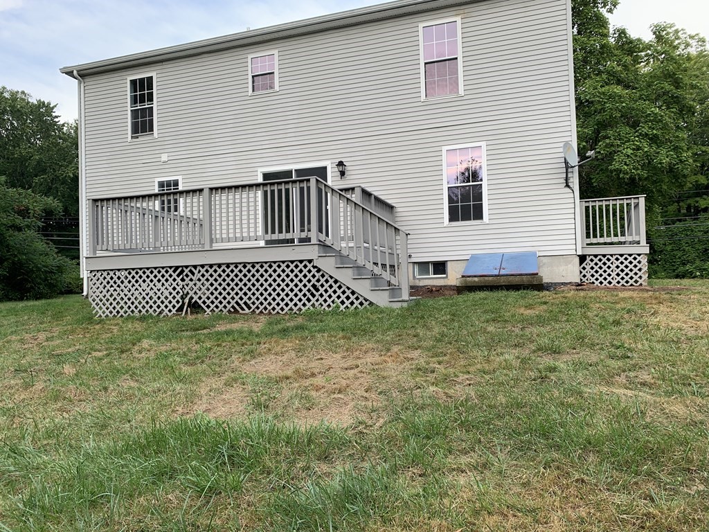 581 Warren Wright Road Belchertown, MA 01007 - Photo 23 of 25 a front view of a house with a yard