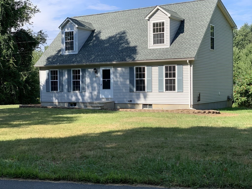 581 Warren Wright Road Belchertown, MA 01007 - Photo 3 of 25 a front view of a house with a yard