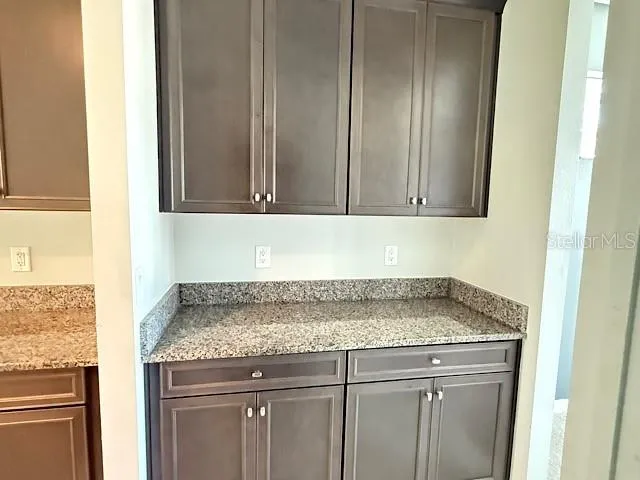 a view of a sink a mirror and cabinets