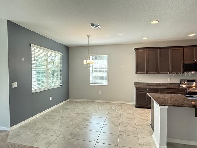 12590 Retreat Place Spring Hill, FL 34610 - Photo 15 of 33 a kitchen with granite countertop a stove sink and cabinets