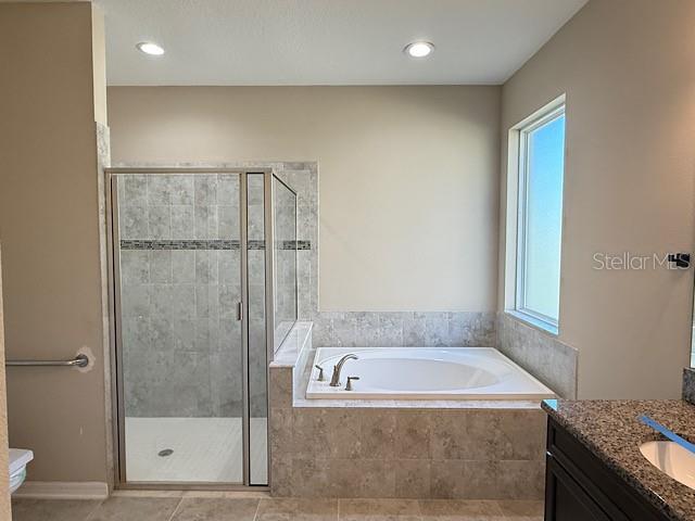 12590 Retreat Place Spring Hill, FL 34610 - Photo 18 of 33 a bathroom with a granite countertop bathtub shower and toilet