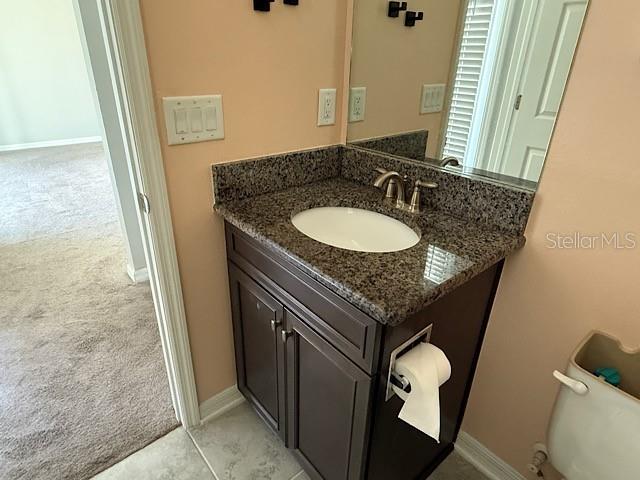 12590 Retreat Place Spring Hill, FL 34610 - Photo 20 of 33 a bath room with sink and a mirror
