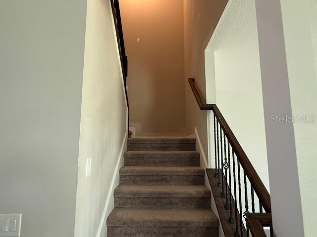 12590 Retreat Place Spring Hill, FL 34610 - Photo 21 of 33 a view of staircase with wooden floor and white door