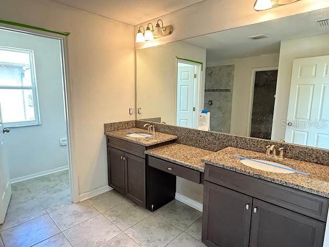 12590 Retreat Place Spring Hill, FL 34610 - Photo 23 of 33 a bathroom with a granite countertop sink and a mirror