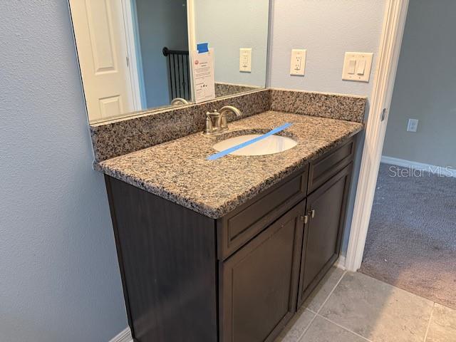 12590 Retreat Place Spring Hill, FL 34610 - Photo 27 of 33 a bathroom with a granite countertop sink and a mirror