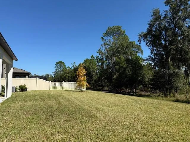 a swimming pool with trees in the background