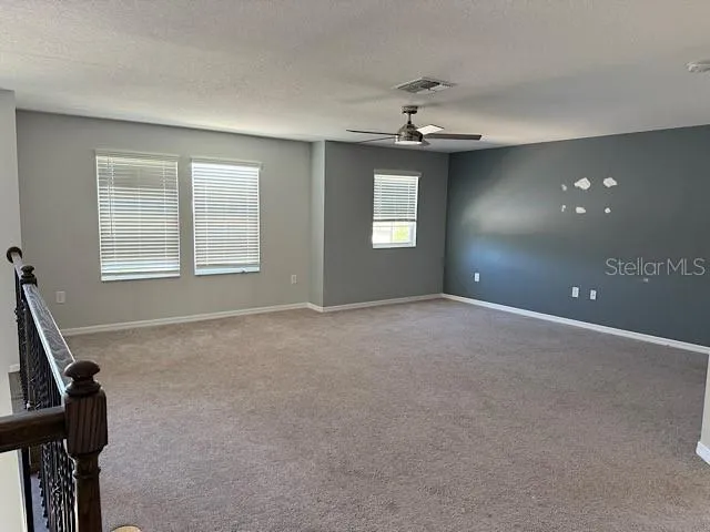 a view of a room with windows chandelier and a window
