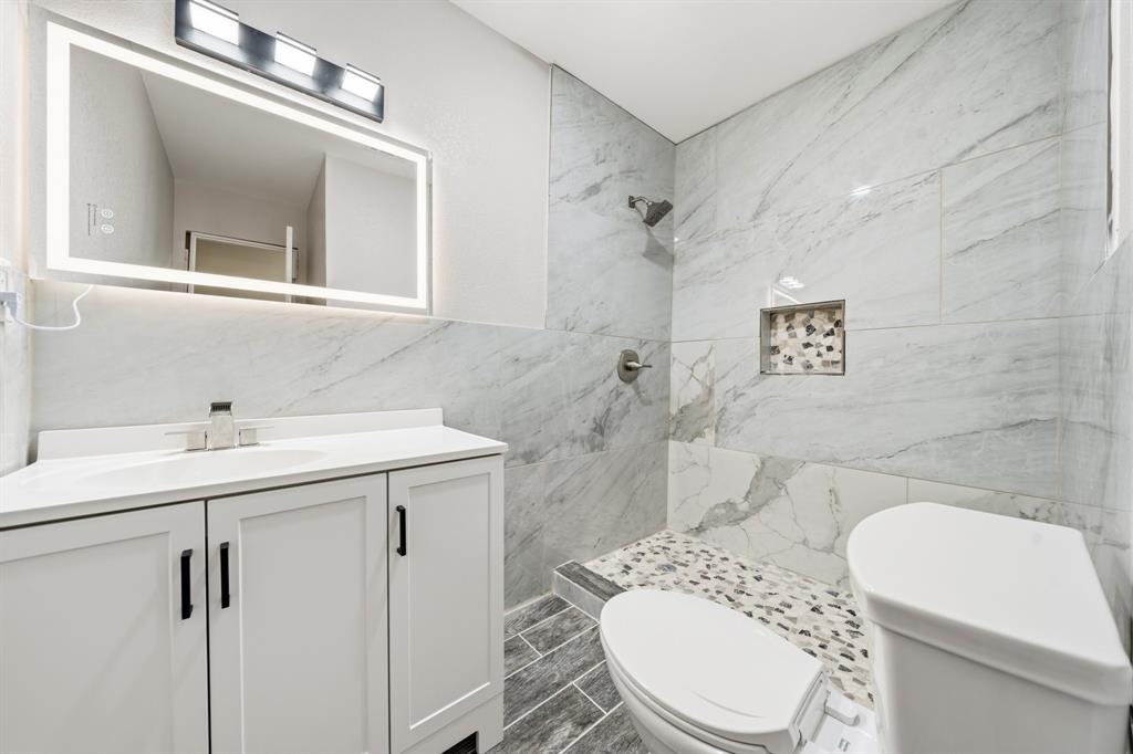 3313 South 3rd Street Waco, TX 76706 - Photo 12 of 28 a bathroom with a sink a toilet and shower