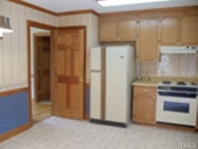 3220 Greenville Loop Road Wake Forest, NC 27587 - Photo 2 of 8 Large eat in kitchen with outside door to deck and window overlooking backyard.