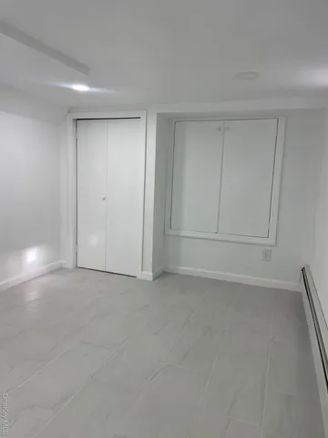 a white toilet sitting next to a bath tub