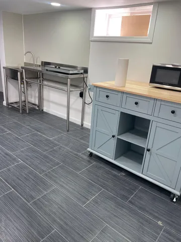 a view of an empty room with stairs and ventilation