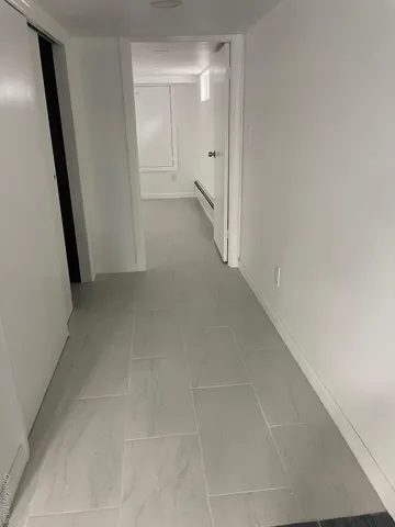 a view of an empty room and a window