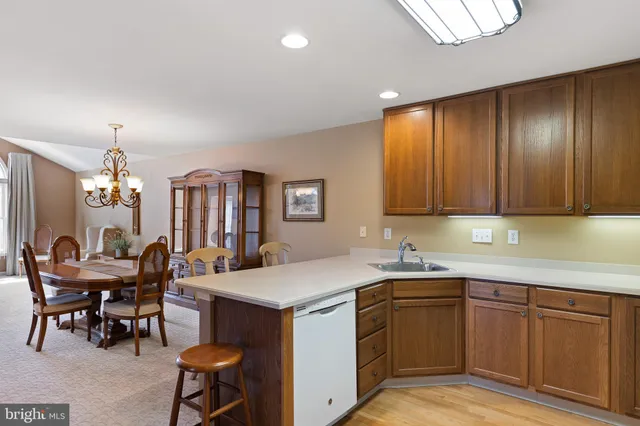 a kitchen with a sink cabinets and wooden floor
