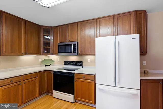a kitchen with stainless steel appliances granite countertop a refrigerator stove a sink and dishwasher