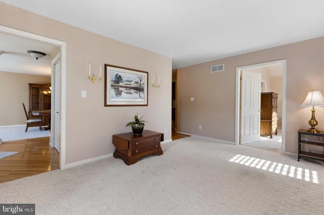 a view of a livingroom with wooden floor and cabinet