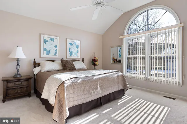 a bedroom with a large bed and a window