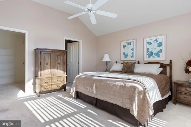 a spacious bedroom with a bed and a chandelier