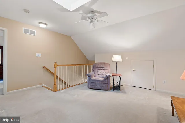 a view of a livingroom with furniture and a chandelier fan