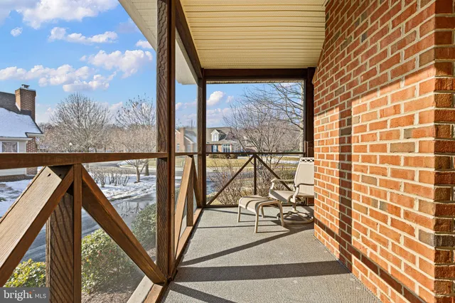 a view of a balcony with wooden floor and iron stairs