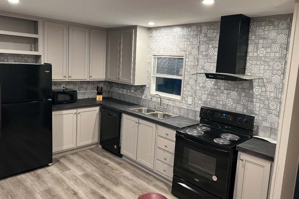 1660 South FM 1660 Taylor, TX 76574 - Photo 18 of 25 a kitchen with a sink stove and refrigerator