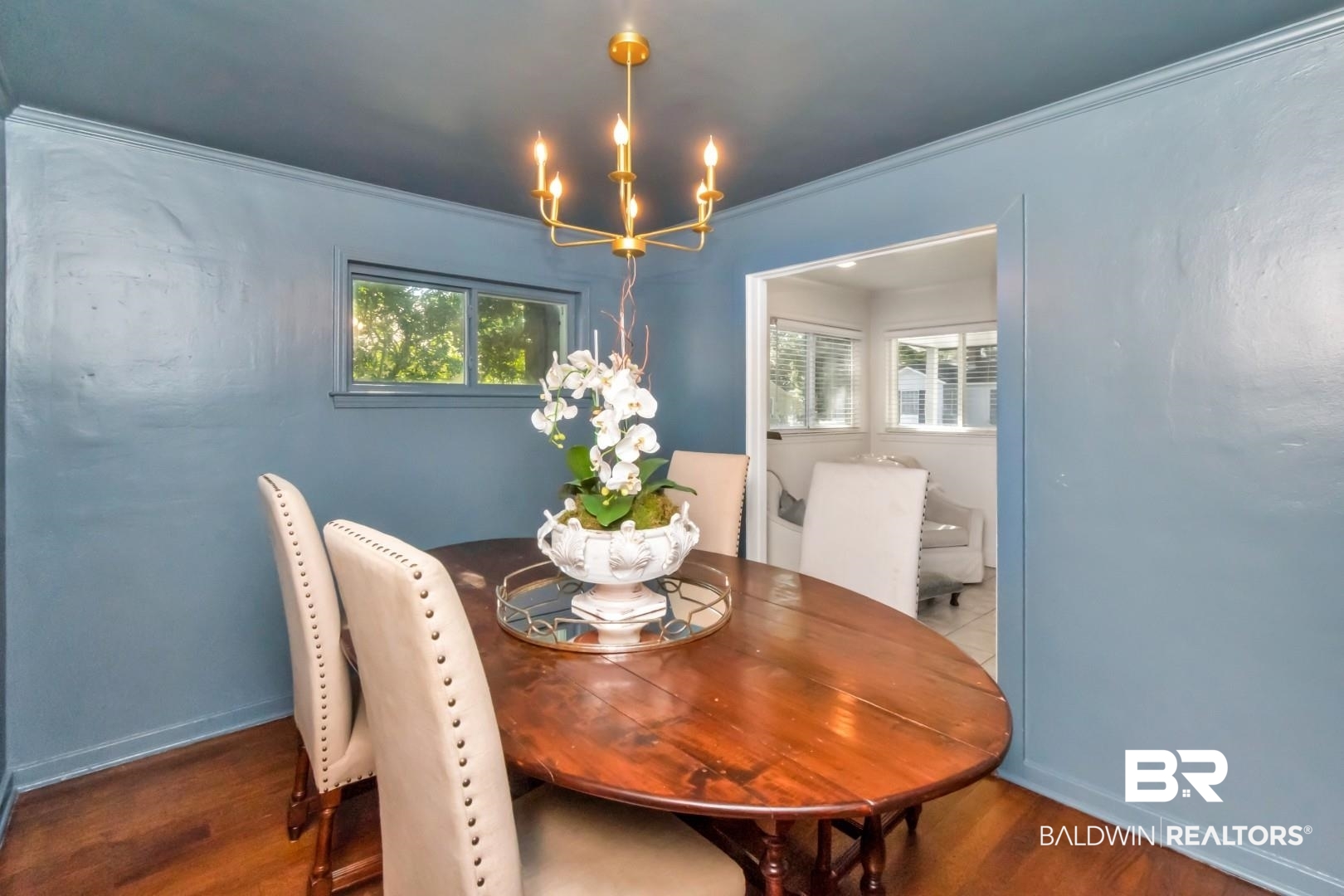 18 Princess Anne Road Mobile, AL 36608 - Photo 7 of 41 Dining room featuring wood finished floors, ornamental molding, and a chandelier