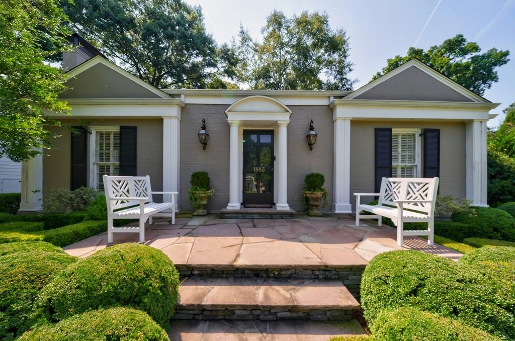 a view of a chair and table in backyard of the house