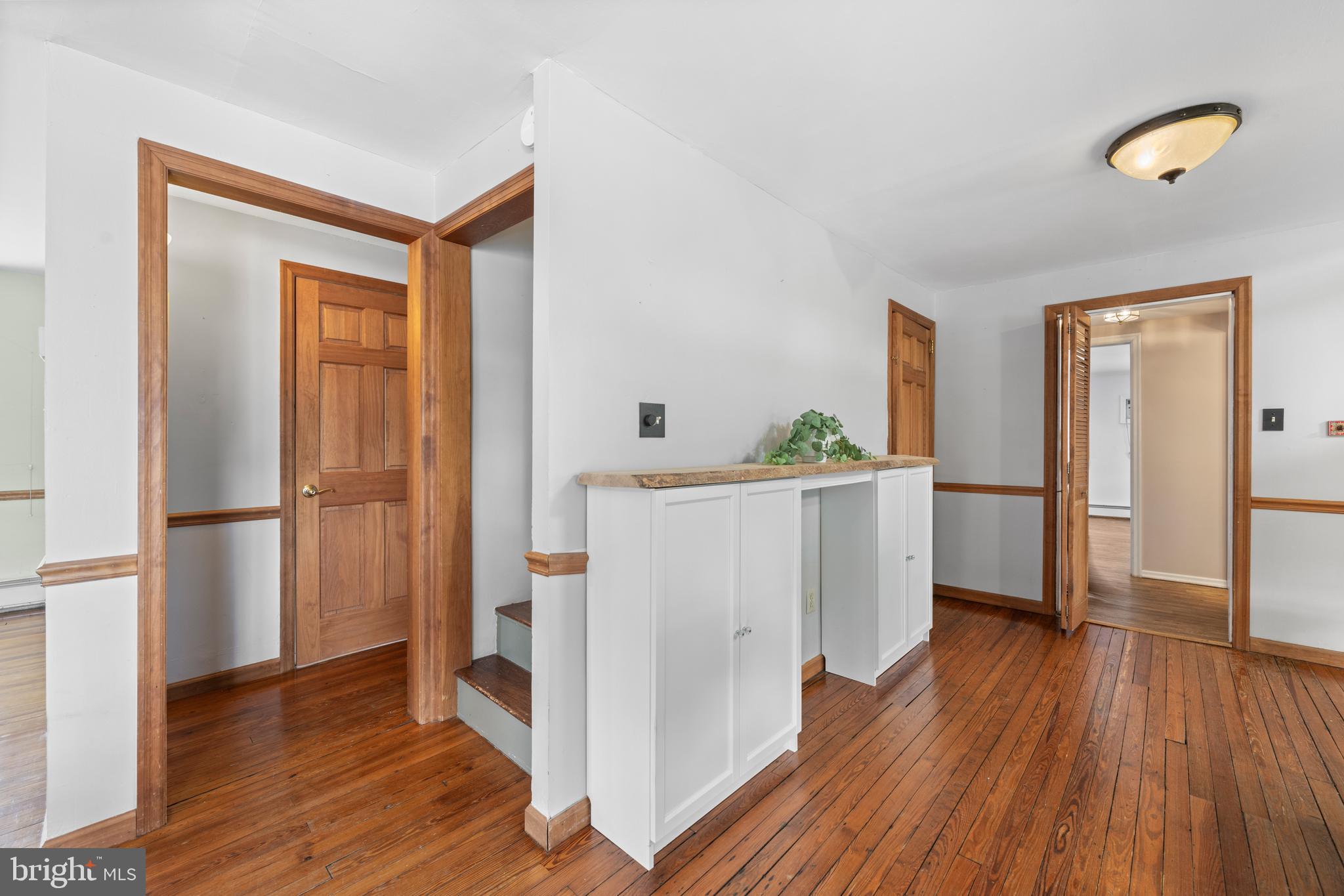 691 Park Road Lansdale, PA 19446 - Photo 28 of 50 a kitchen with white cabinets and wooden floor