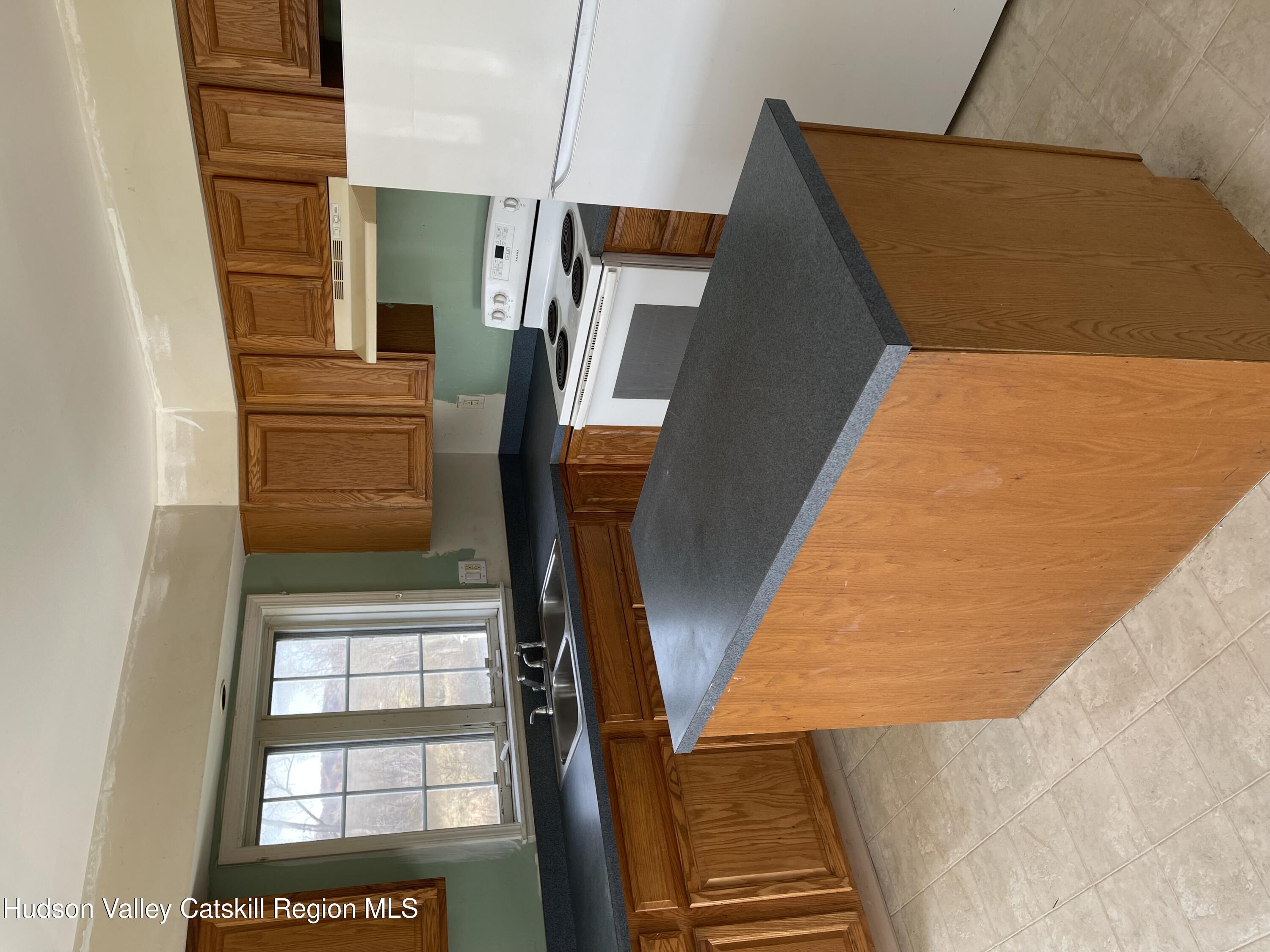 a kitchen with granite countertop a sink a counter top space and appliances