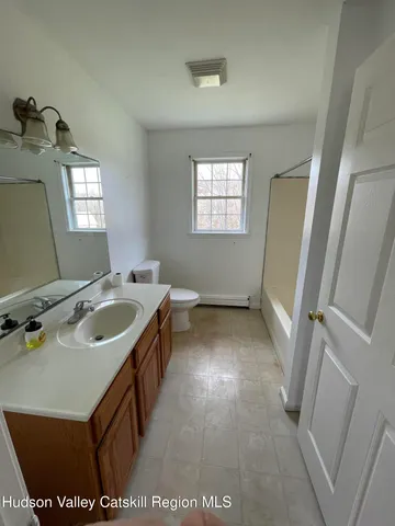 a bathroom with a sink a vanity and a mirror