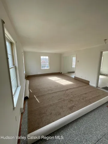 a view of an empty room and wooden floor